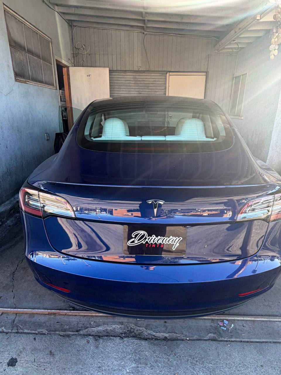 Blue Tesla Model 3 — before tint, rear view